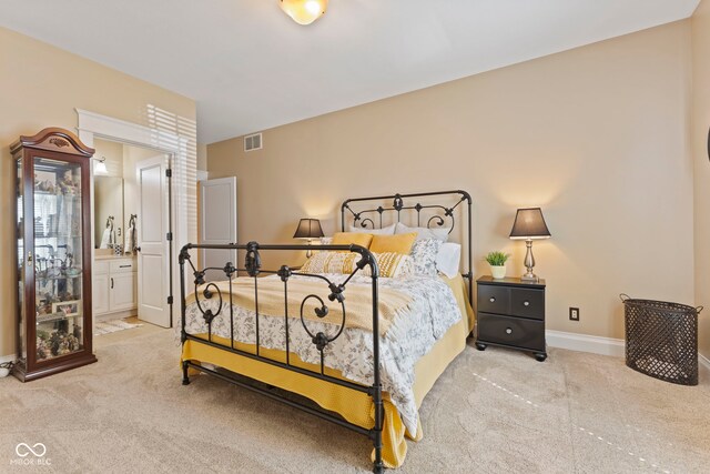 bedroom featuring ensuite bath, visible vents, carpet flooring, and baseboards