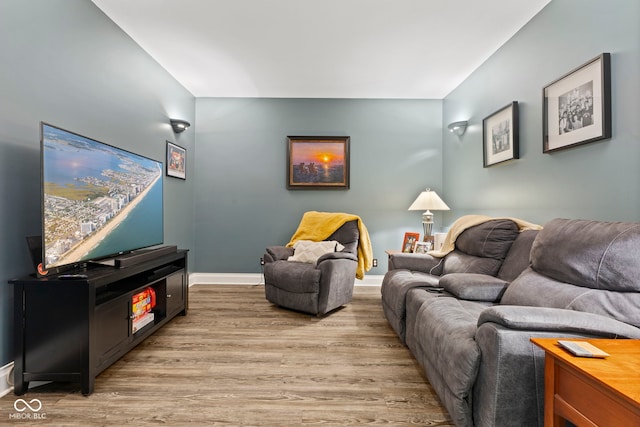 living room featuring baseboards and light wood-type flooring
