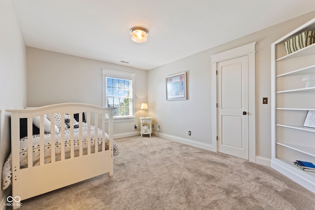 bedroom with baseboards, visible vents, and carpet floors