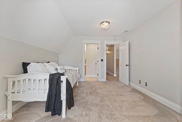 carpeted bedroom with vaulted ceiling