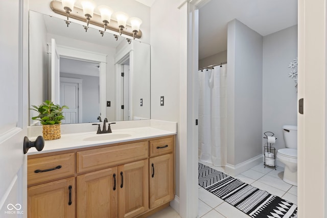 bathroom with vanity, toilet, and tile patterned floors