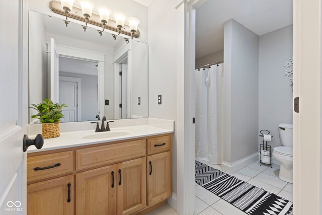 full bathroom with curtained shower, baseboards, toilet, vanity, and tile patterned flooring