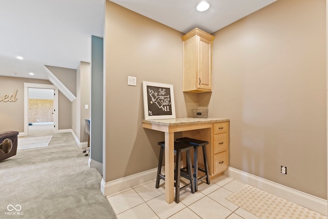 interior space with light brown cabinetry and light carpet