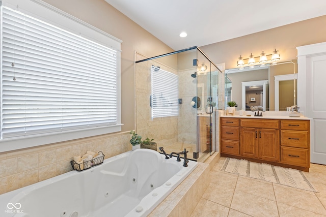 bathroom with plus walk in shower, tile patterned floors, and vanity