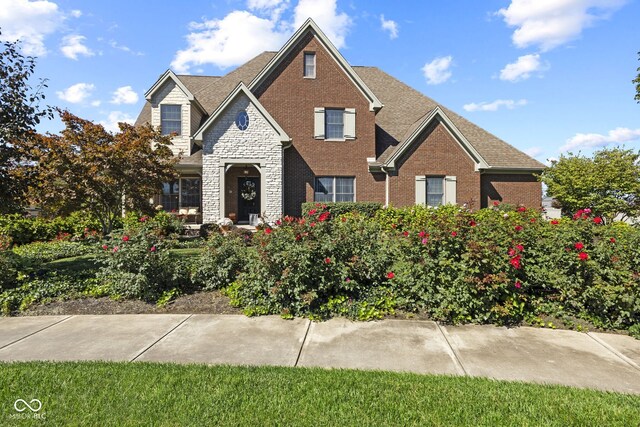 view of front of house featuring brick siding and stone siding