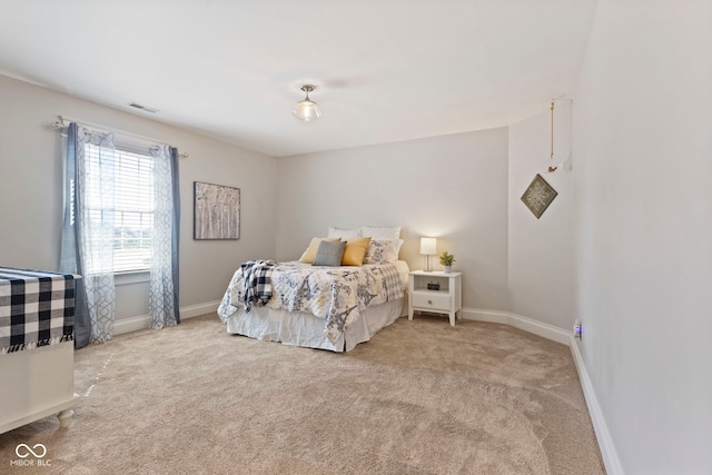 bedroom with carpet, visible vents, and baseboards