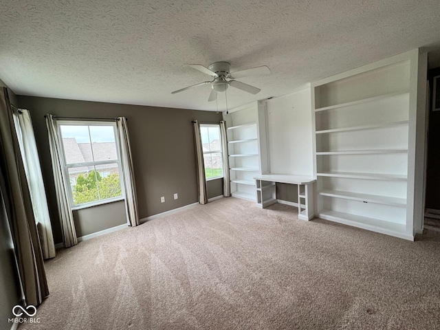 unfurnished living room with a textured ceiling and light colored carpet