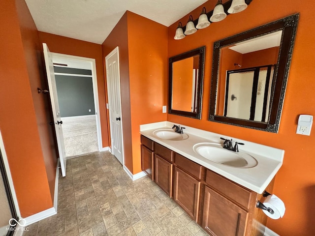 bathroom with a shower with door and vanity