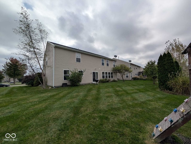 back of house featuring a yard