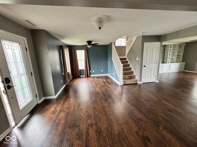 foyer featuring a textured ceiling, ceiling fan, and dark hardwood / wood-style flooring