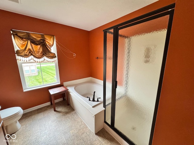 bathroom featuring separate shower and tub and toilet