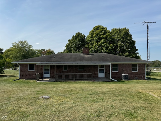 rear view of property with a yard, a patio area, and central air condition unit