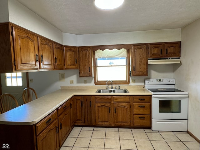 kitchen featuring a wealth of natural light, white range with electric stovetop, sink, and light tile patterned floors