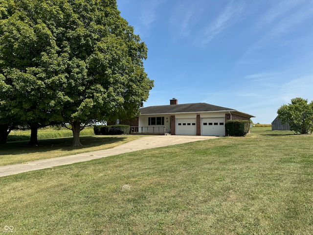 view of front of home with a front yard and a garage