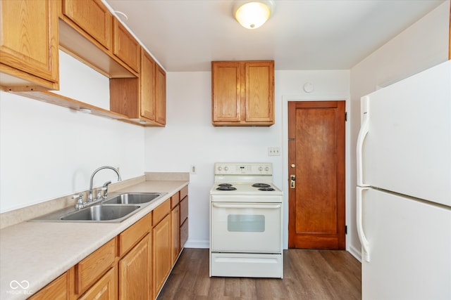 kitchen featuring white appliances, dark hardwood / wood-style flooring, and sink