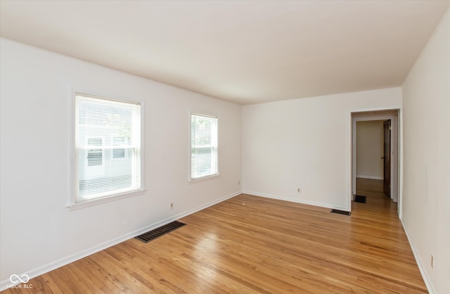 unfurnished room with a wealth of natural light and light wood-type flooring