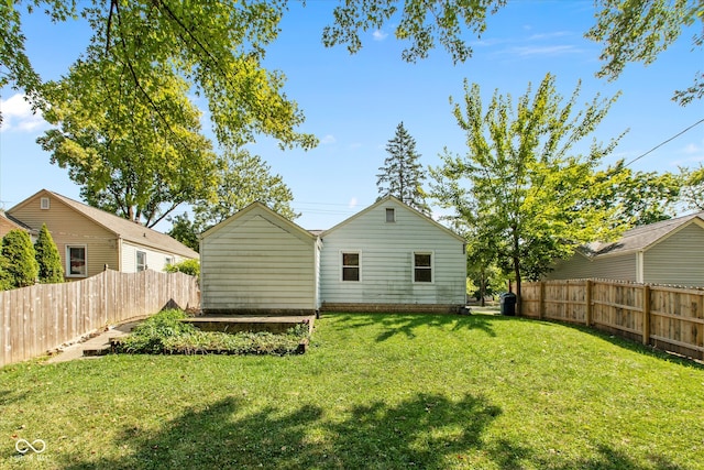 back of property featuring a yard