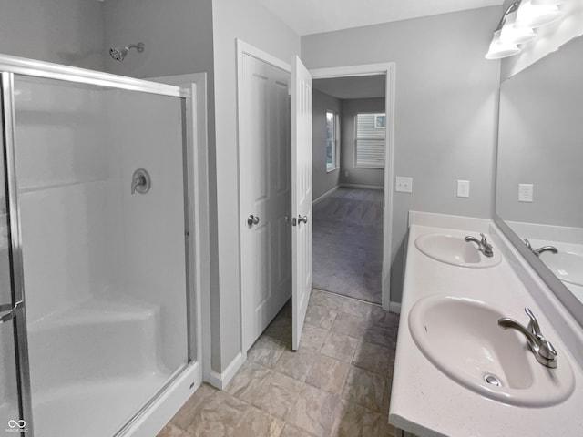 bathroom with a shower with shower door and vanity