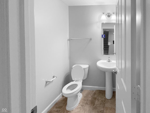 bathroom with tile patterned flooring and toilet