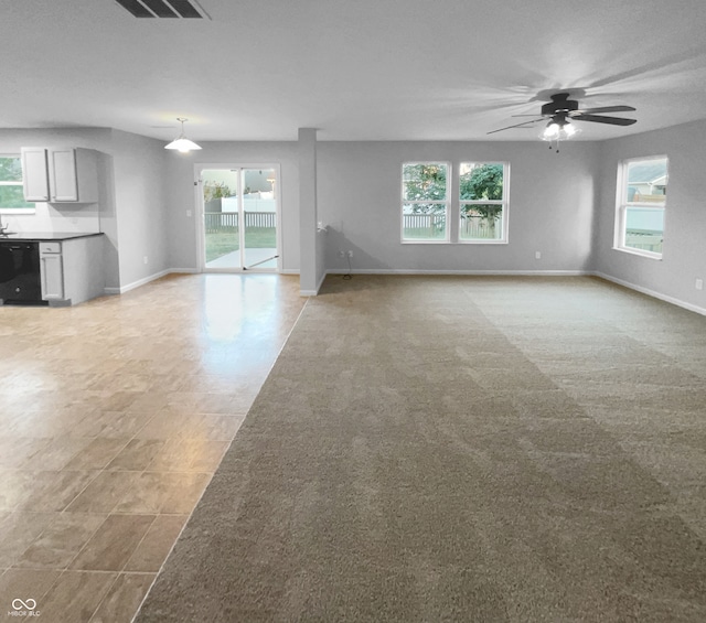 unfurnished living room featuring a wealth of natural light