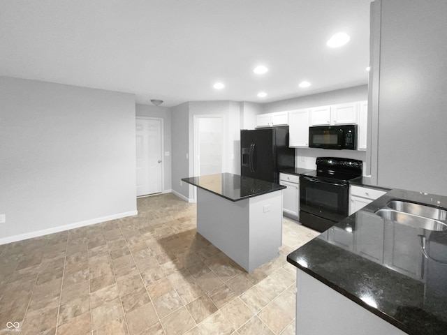 kitchen with black appliances, dark stone countertops, a center island, and white cabinetry