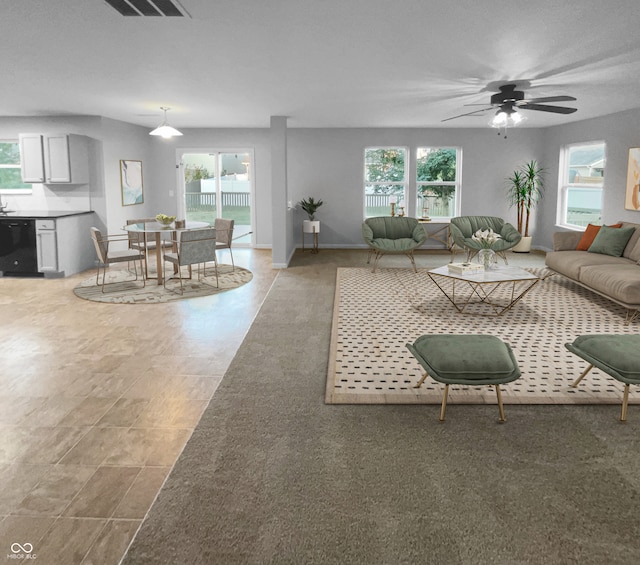 living room with ceiling fan and plenty of natural light