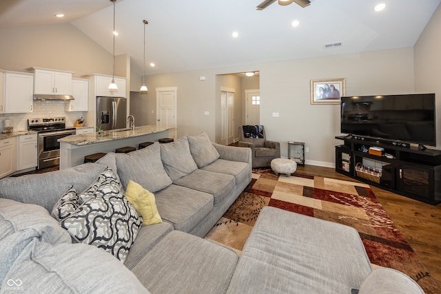 1569 Tupelo Dr, Greenfield, IN 46140 - living room featuring wood finished floors, ceiling fan, high vaulted ceiling, recessed lighting, and baseboards