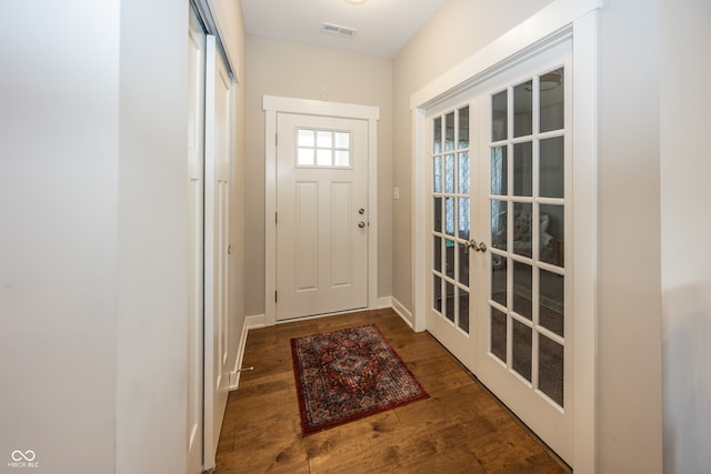 1569 Tupelo Dr, Greenfield, IN 46140 - doorway to outside featuring french doors, wood finished floors, and baseboards