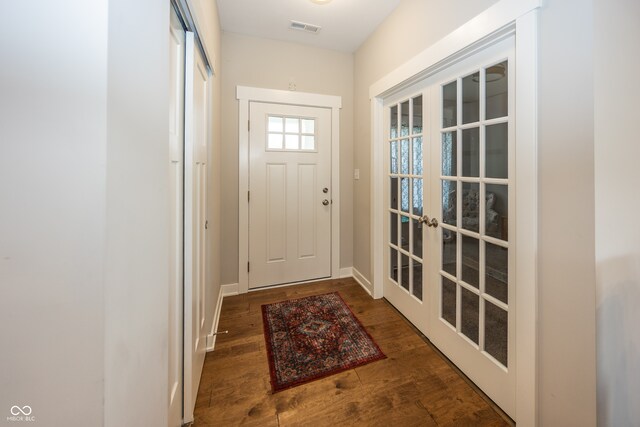 1569 Tupelo Dr, Greenfield, IN 46140 - doorway to outside featuring french doors, wood finished floors, and baseboards