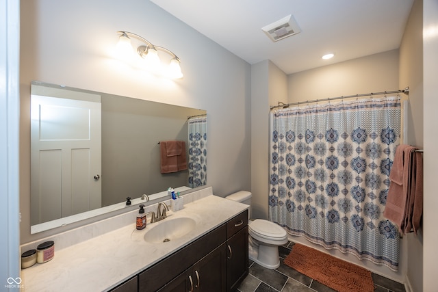 bathroom featuring curtained shower, toilet, and vanity