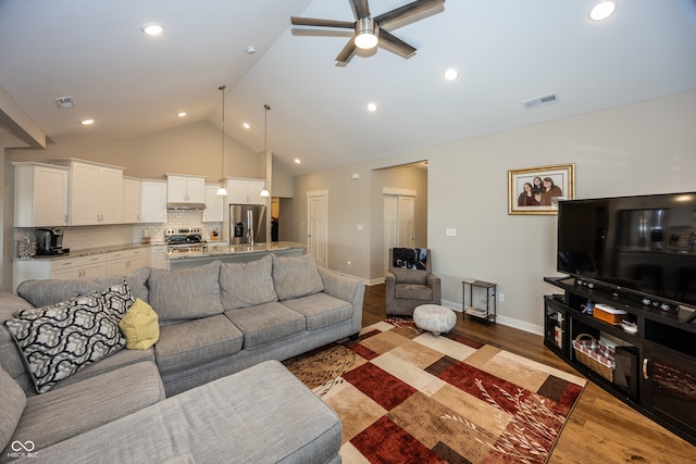 living room with lofted ceiling, ceiling fan, and light hardwood / wood-style flooring