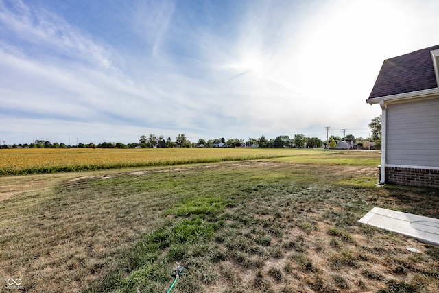 view of yard with a rural view