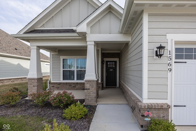 1569 Tupelo Dr, Greenfield, IN 46140 - property entrance with board and batten siding, covered porch, and brick siding