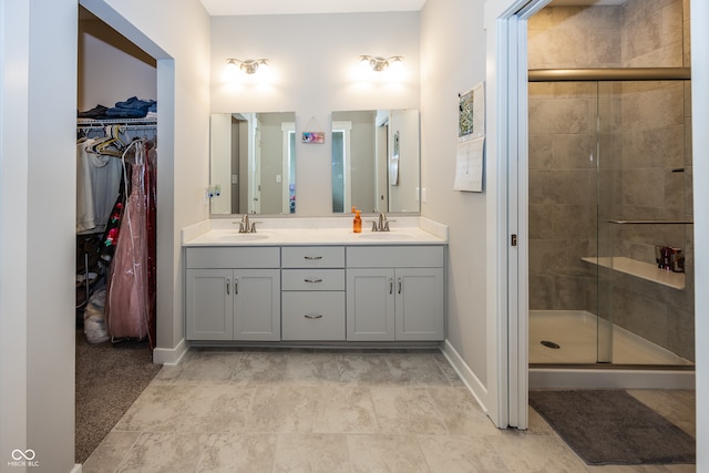 bathroom with a shower with door and vanity