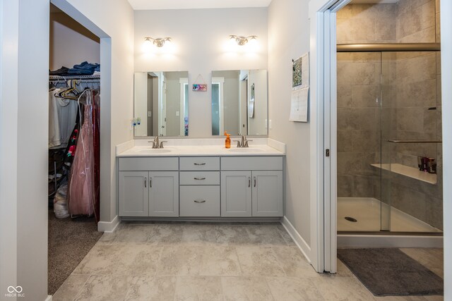 1569 Tupelo Dr, Greenfield, IN 46140 - bathroom featuring double vanity, a stall shower, and baseboards