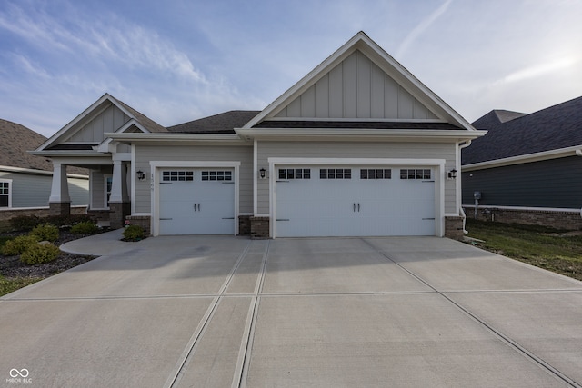 1569 Tupelo Dr, Greenfield, IN 46140 - craftsman house featuring board and batten siding, an attached garage, driveway, and brick siding