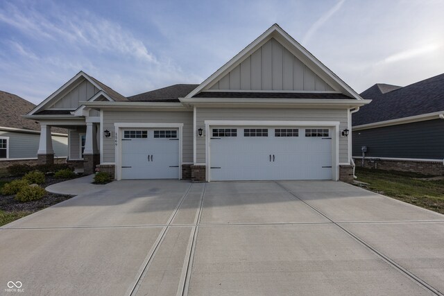 1569 Tupelo Dr, Greenfield, IN 46140 - craftsman house featuring board and batten siding, an attached garage, driveway, and brick siding
