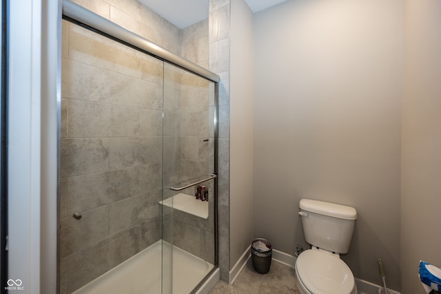 1569 Tupelo Dr, Greenfield, IN 46140 - bathroom featuring a shower stall, toilet, baseboards, and tile patterned flooring
