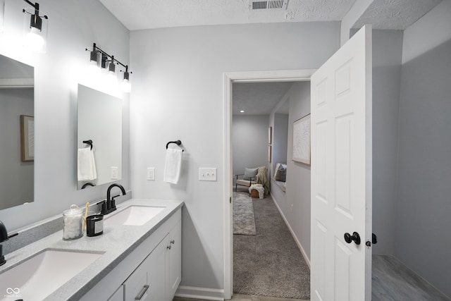 bathroom with vanity and a textured ceiling