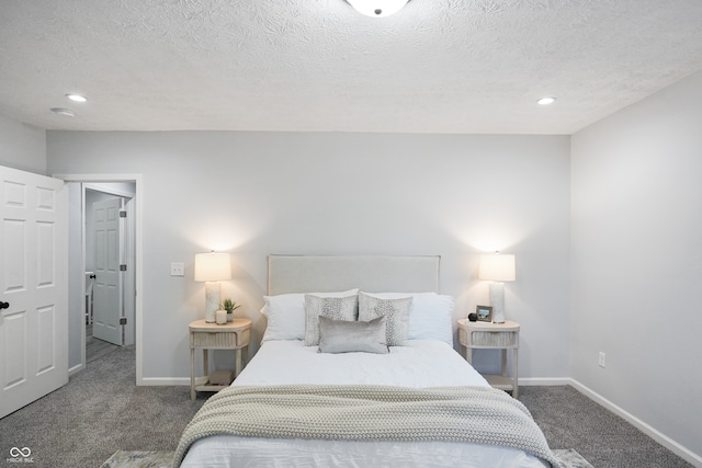 carpeted bedroom featuring a textured ceiling