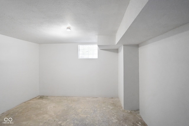 basement featuring a textured ceiling