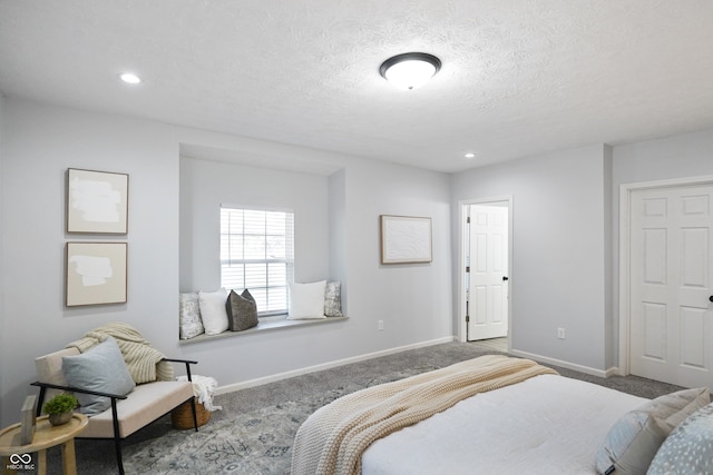 carpeted bedroom featuring a textured ceiling