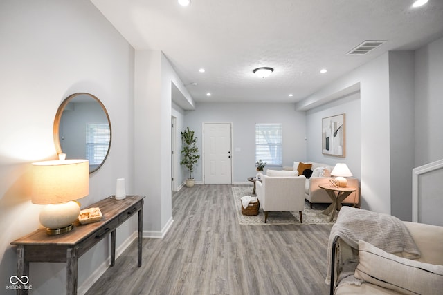 living room featuring a textured ceiling and light wood-type flooring