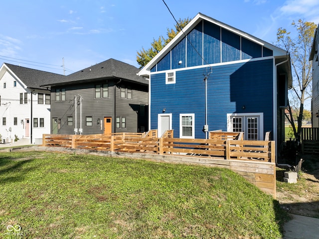 rear view of house featuring a lawn