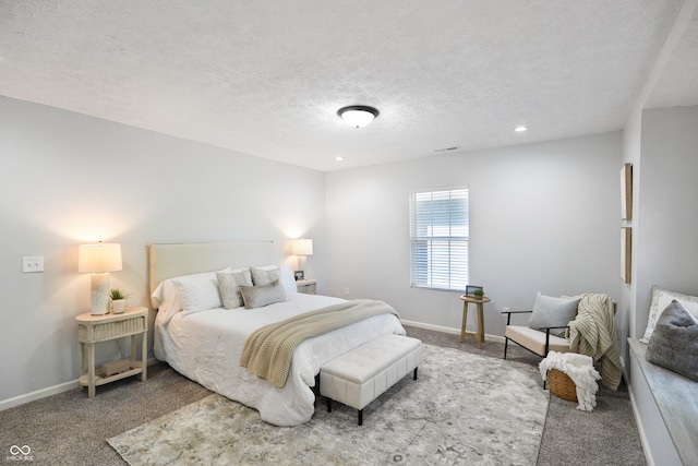 bedroom featuring a textured ceiling and light colored carpet