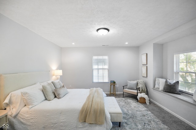 carpeted bedroom with a textured ceiling