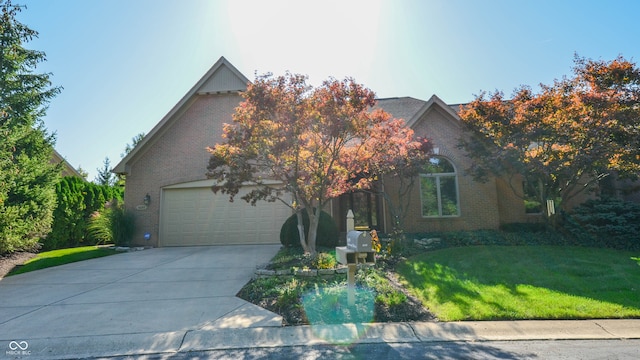 view of property hidden behind natural elements with a garage and a front yard