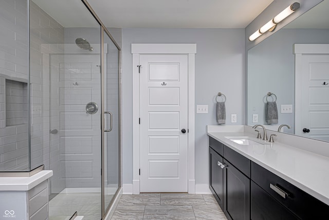 bathroom featuring vanity and a shower with shower door