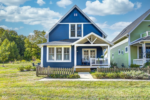 view of front of home with covered porch and a front lawn