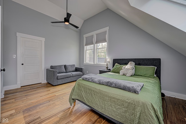 bedroom featuring ceiling fan, lofted ceiling, and hardwood / wood-style floors